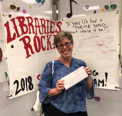 library patron holding prize envelope