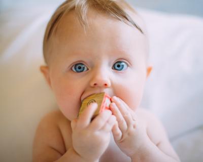 Baby with wooden block