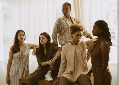 A group of multi-ethnic women, looking stoic and strong.