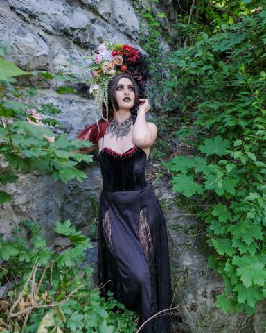 Image of model wearing flower headdress and lace costume against a natural rock and greenery Image of model wearing flower headdress and lace costume against a natural rock and greenery