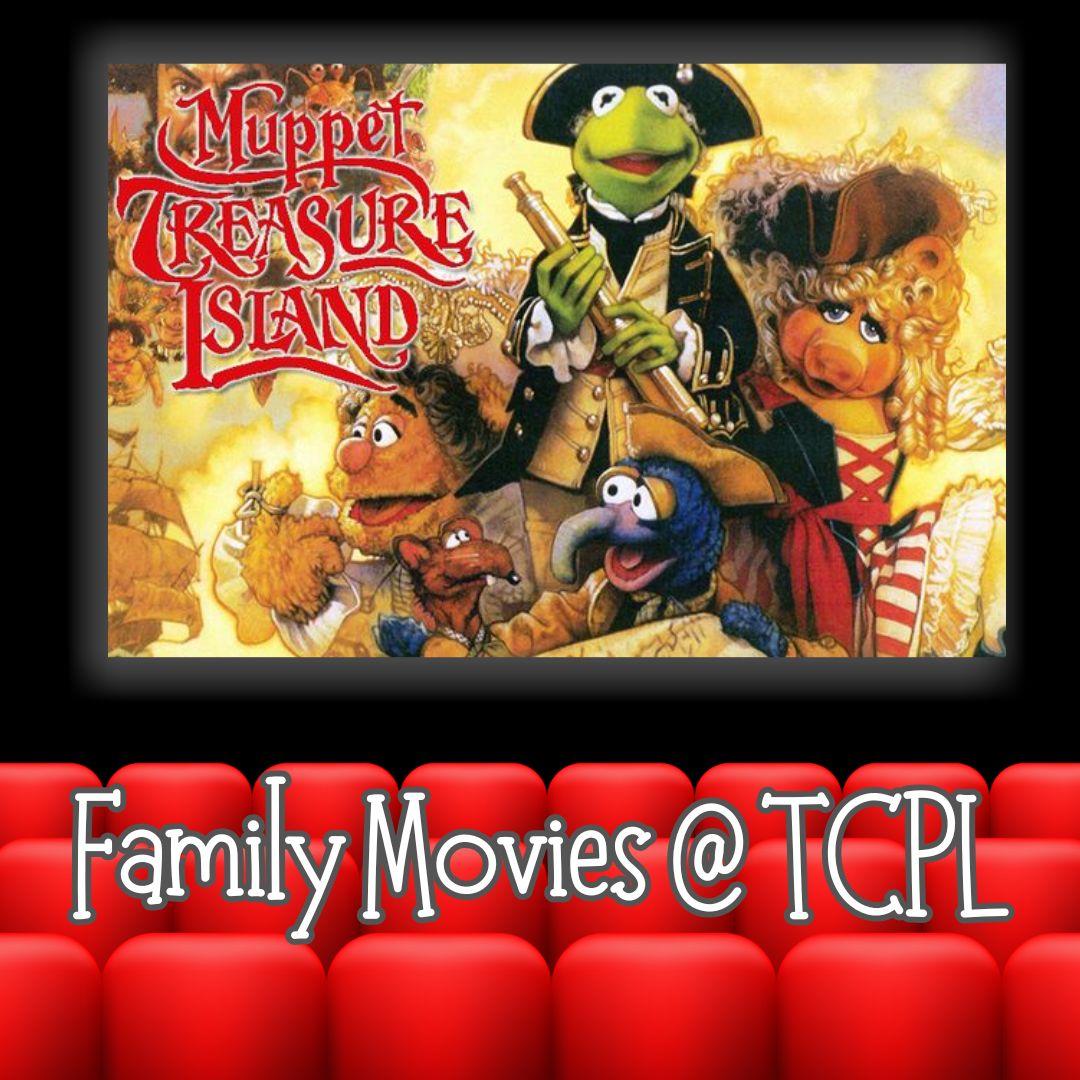 image from Muppets treasure island on the screen at a movie theater with red seat in front.